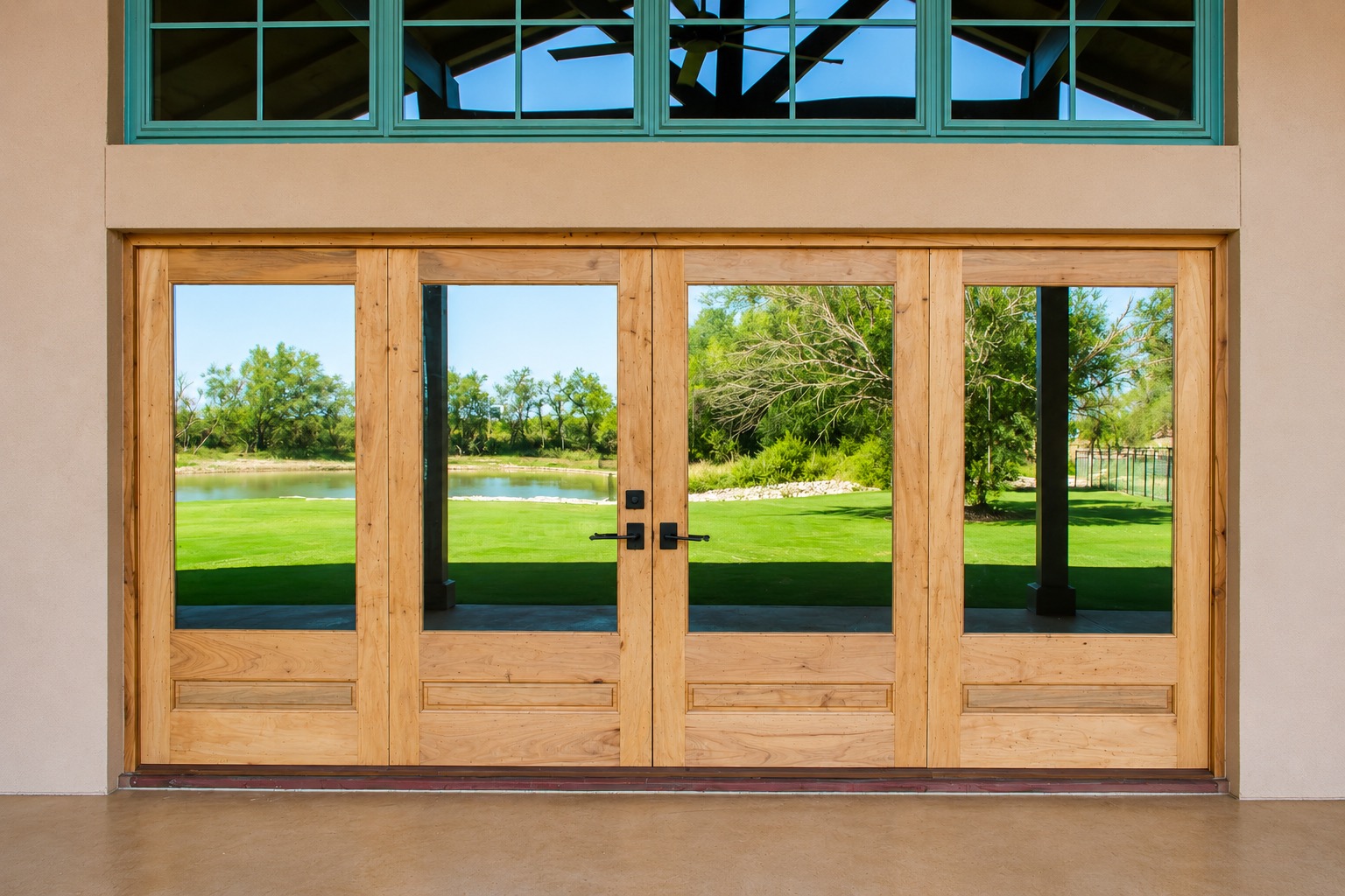 Wood French doors with a transom window above