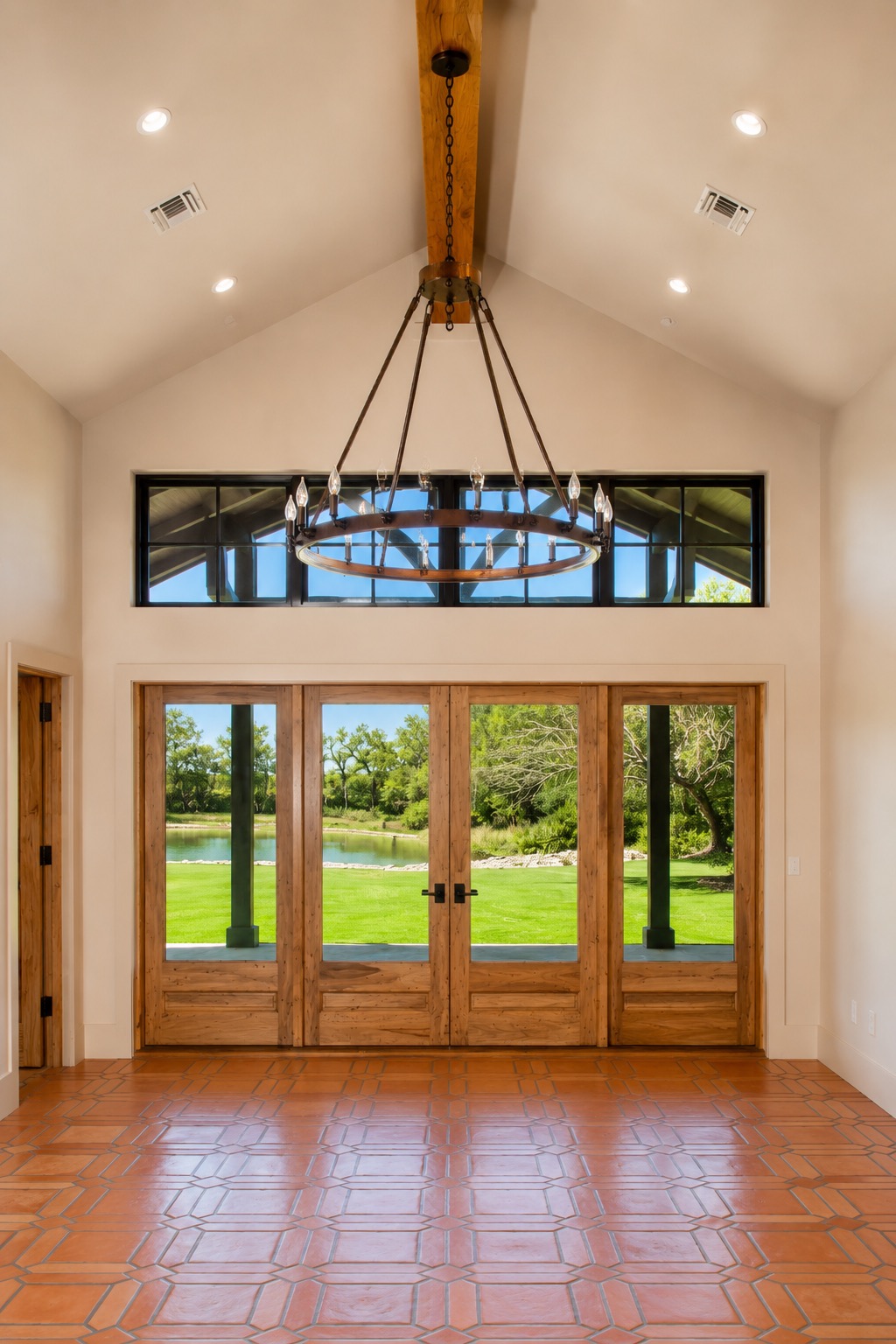 Great room with vaulted ceiling, chandelier and French doors