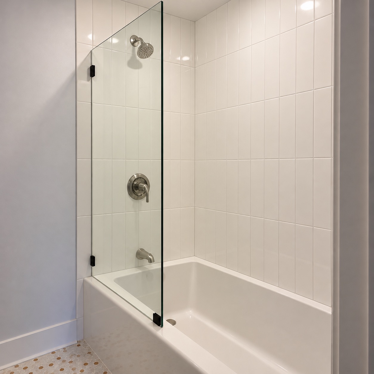 Tub and shower with glass panel and white tile