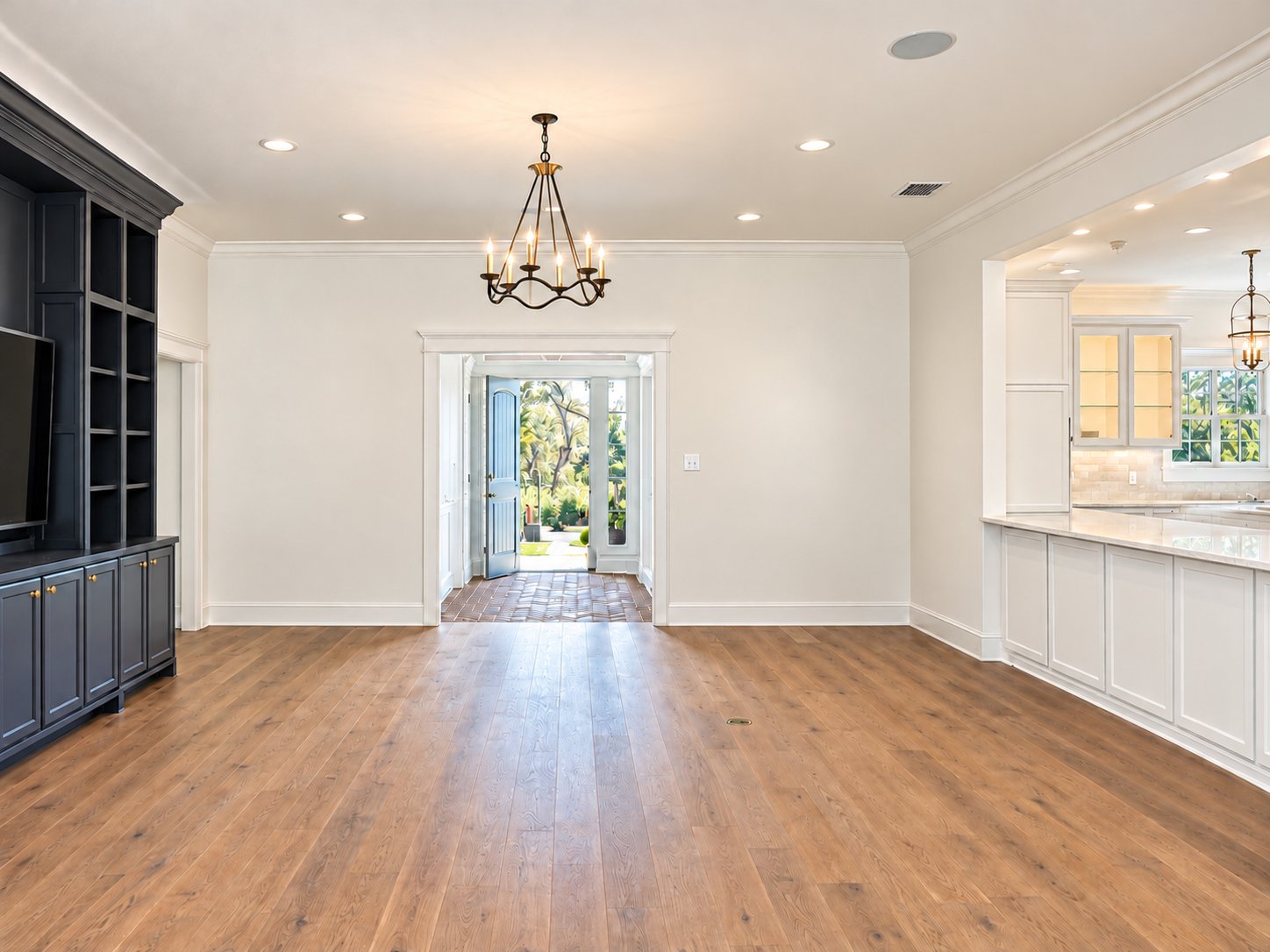 Living room with dark built-in media cabinet, looking back to the entry