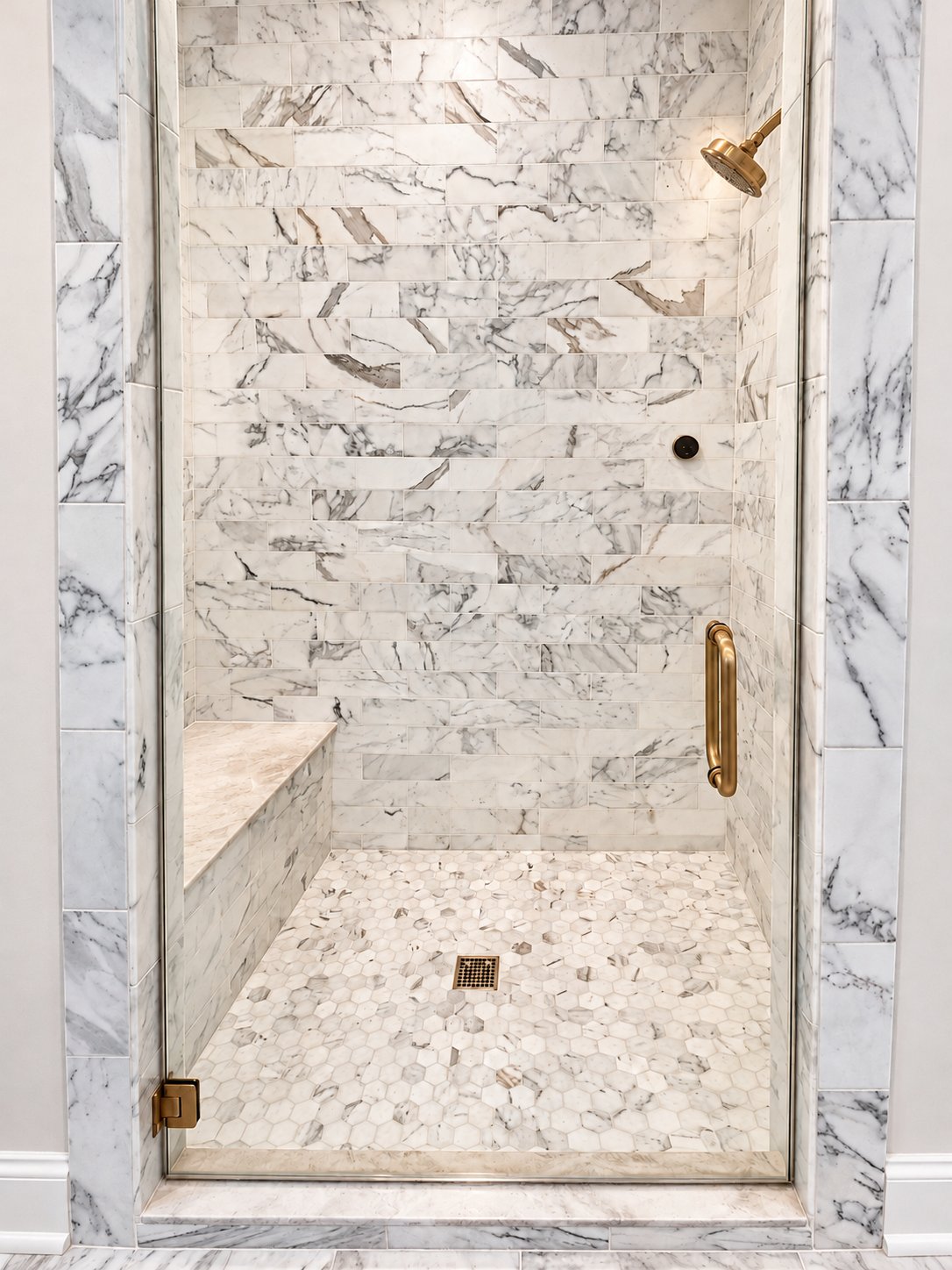 Walk-in shower with bench, hex tile floor and glass door